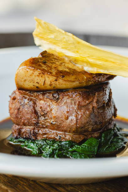 istock Appetizing steak on a bed of spinach. Foie gras with Madeira sauce 2011302677
