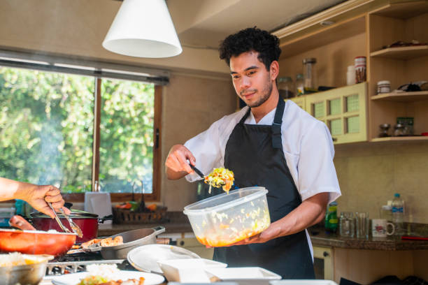 Chef preparing savory meat inside dimly lit food truck, crafting authentic mexican street food during nighttime culinary rush