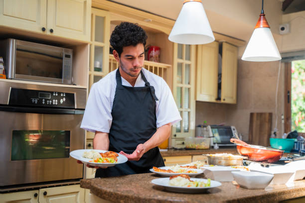 Man is serving the nursing home restaurant's buffet lunch