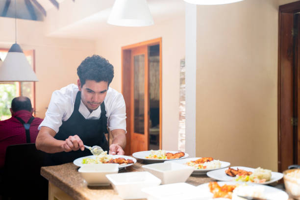 istock Man is serving the nursing home restaurant's buffet lunch 2011321061