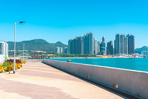 View of a Tseung Kwan O waterfront promenade under blue sky