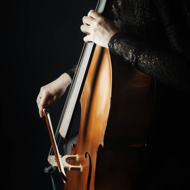 istock Cello. Cellist hands playing violoncello close up 2011335472