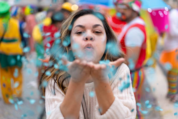 istock Woman blowing confetti at carnival 2011374868