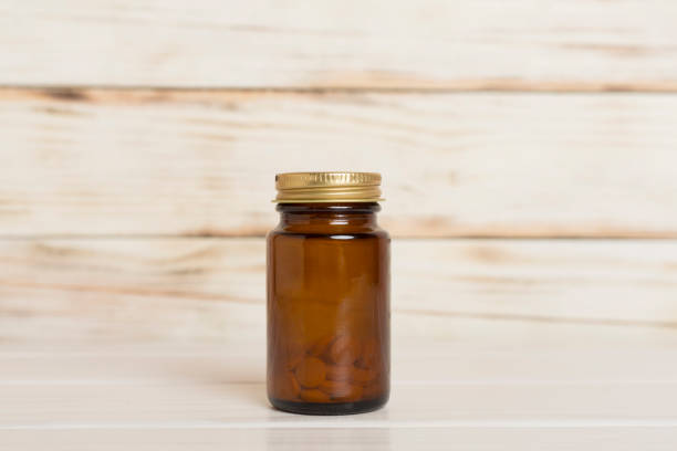 Plastic bottle for vitamins on wooden table
