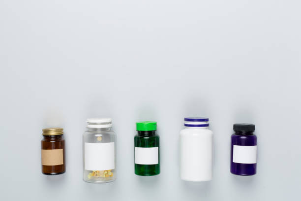 istock Plastic bottles with vitamins on color background, top view 2011393212