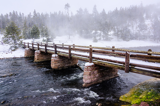 Firehole River Bridge in winter in Yellowstone National Park, Wyoming.