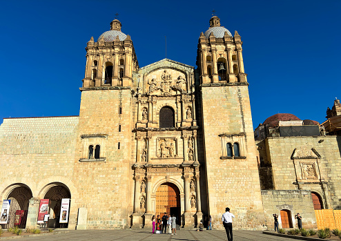 Oaxaca, Mexico: Tourists outside the sunlit Church of Santo Domingo de Guzman in downtown Oaxaca, inaugurated in 1608.