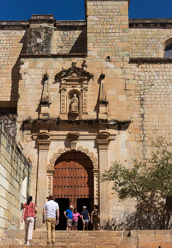 Oaxaca, Mexico: Tourists outside the side entrance of the Church of Santo Domingo de Guzman in downtown Oaxaca, inaugurated in 1608.