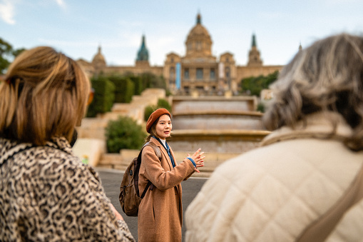 Tourist guide showing Barcelona city to a group of seniors