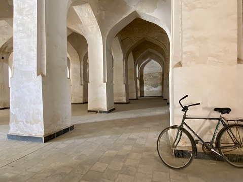 Men's bicycle resting on the arcades of the Kalyan (also called Kalan) Mosque complex in Bukhara, Uzbekistan