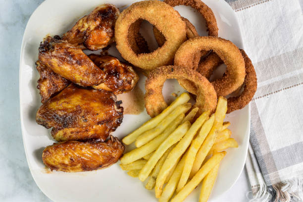 Closeup shot of French fries and fried chicken on basket