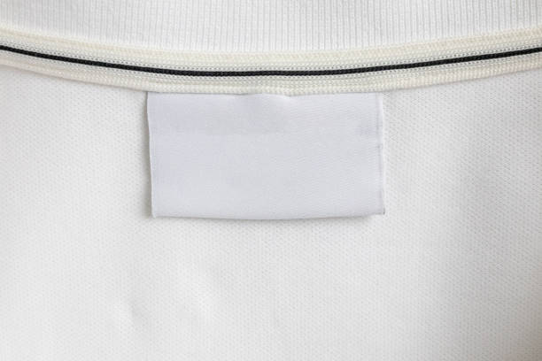 istock Blank white laundry care clothes label on white shirt fabric texture background 2011480720