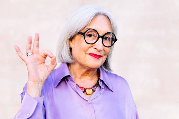 istock friendly senior woman making ok symbol with hand 2011485037