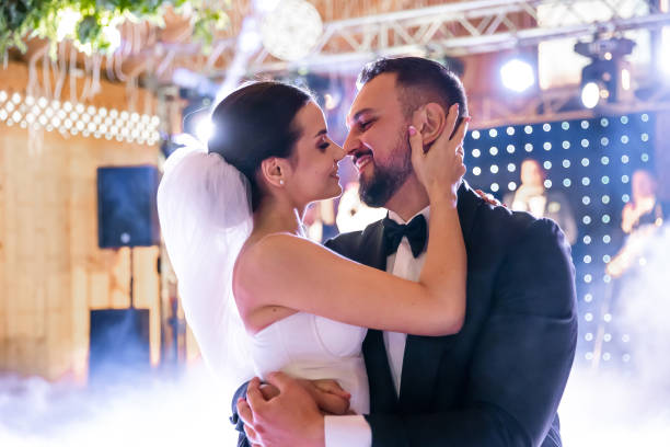 istock the bride and groom dance the first dance indoors. 2011487226