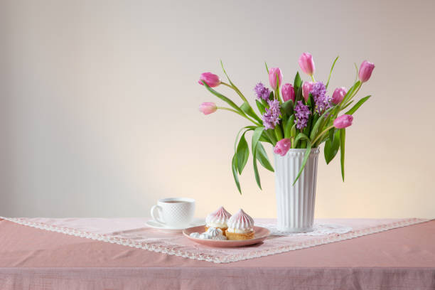 istock cup of tea and cupcakes with spring flowers in light colors 2011487789