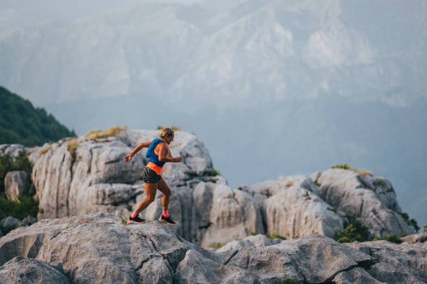 istock An extreme skyrunner is running on rocky mountains. 2011490113