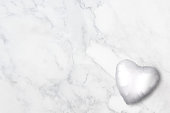 White heart balloon on a marble background