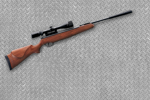 Hunting air rifle on a industrial metal background