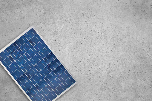 Solar panel on an industrial cement concrete background