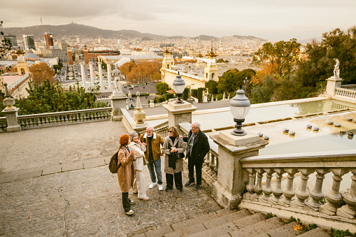 Tourist guide showing Barcelona city views to a group of seniors