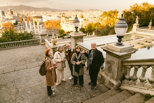 Tourist guide showing Barcelona city views to a group of seniors