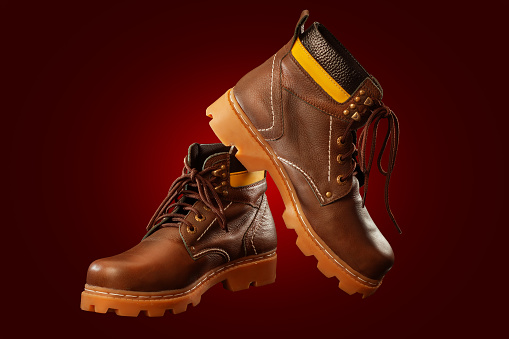 A Pair of Protective semi-boots designed for safety and durability in red background