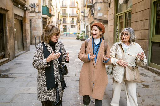 Tourist guide showing Barcelona Historic district to a group of seniors