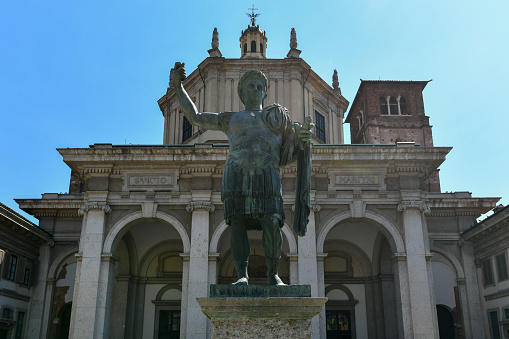 Milan, Italy - Aug 4, 2022: Basilica of Saint Lawrence (San Lorenzo) and the statue of Emperor Constantine in Milan. Built in the 4th century AD it is the oldest church in Milan.