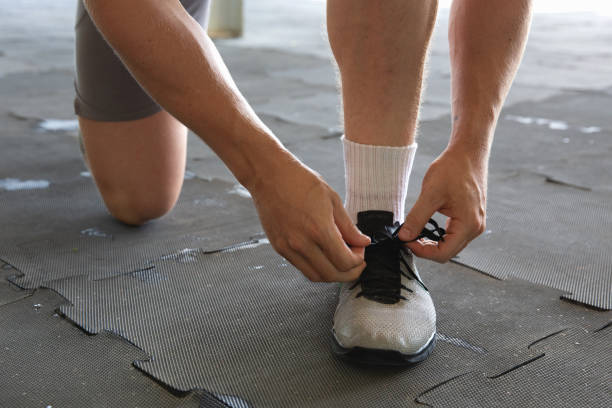 istock Unrecognizable Man Tying Up Shoelaces 2011593718