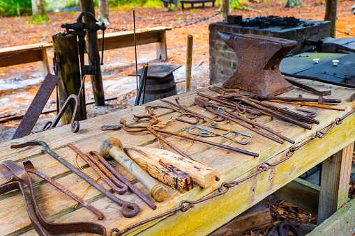 Set of vintage rusty blacksmith tools on the table outdoors
