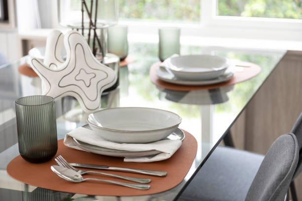 istock White and brown plate setting on dinning table in a dining room 2011729496