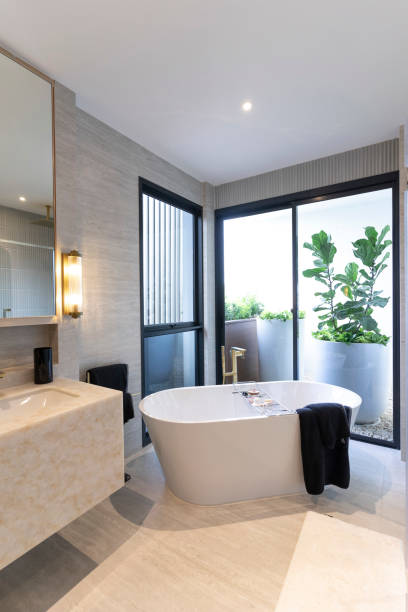 istock Spacious and bright modern bathroom with white bathtub. 2011731579
