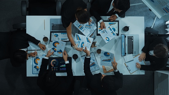 Time lapse of diverse marketing team prepare for business meeting. Top down aerial view of businesspeople placed laptop and tablet with financial statistic at table. Creative business. Directorate.