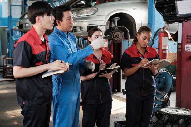 istock A supervisor engineer is training mechanic workers about car repair at a garage. 2011753142