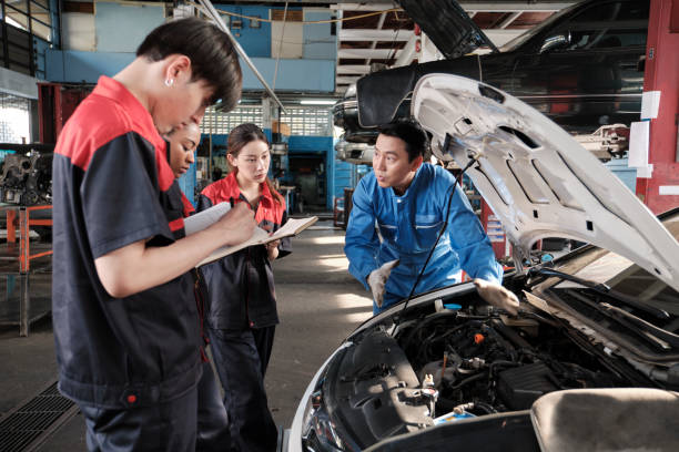 istock Supervisor engineer is teaching mechanic workers about car repair at a garage. 2011755243
