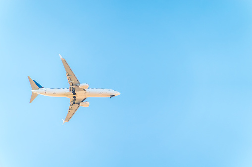 Airplane before landing in blue sky, Boeing 737-800. Air Transport. Tourism and travel concept.