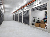 Self Storage Warehouse Building. Empty Corridor With Self Storage Units. Cardboard Boxes, Bicycle And Other Equipments In Open Unit