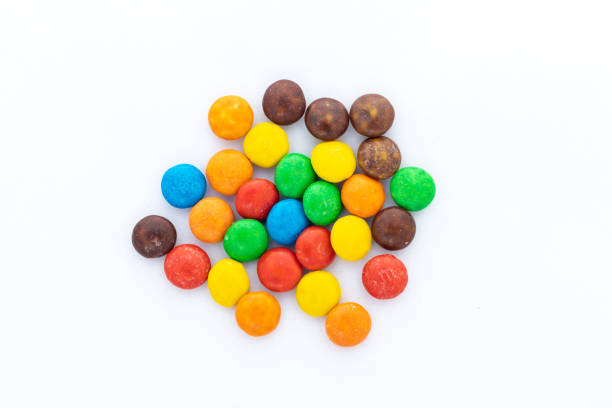 Multicolor delicious chocolate button candies on white isolated background