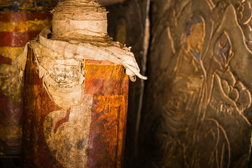 Ancient prayer wheel tattered from age reveals written script below the outer layers, Wangi Dzong, Bhutan, Asia