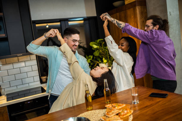 istock Multi-ethnic friends with pizza and bottles of drinks having party 2011973025