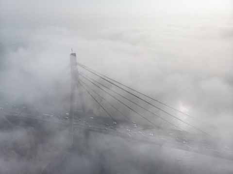 Bridge and river hidden by fog