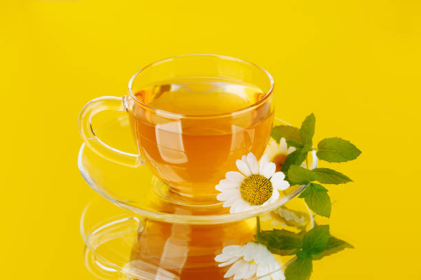 Soothing herbal tea blend with mint and chamomile. On yellow background