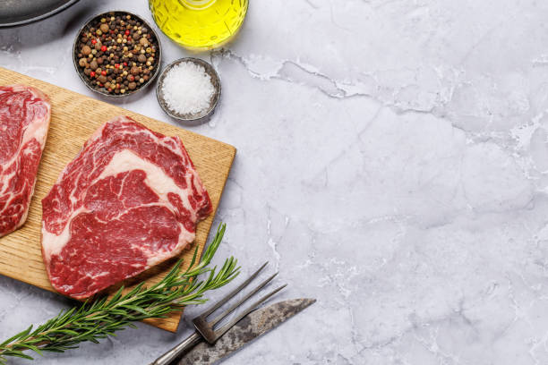 istock Raw ribeye steaks with savory spices 2012013840
