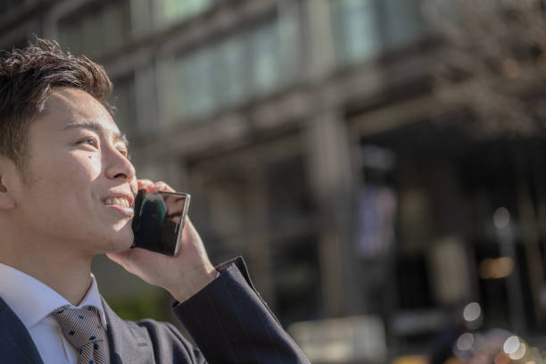 istock walking businessman with phone 2012016516