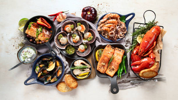 istock Set of Seafood dishes on light wooden background. 2012019646