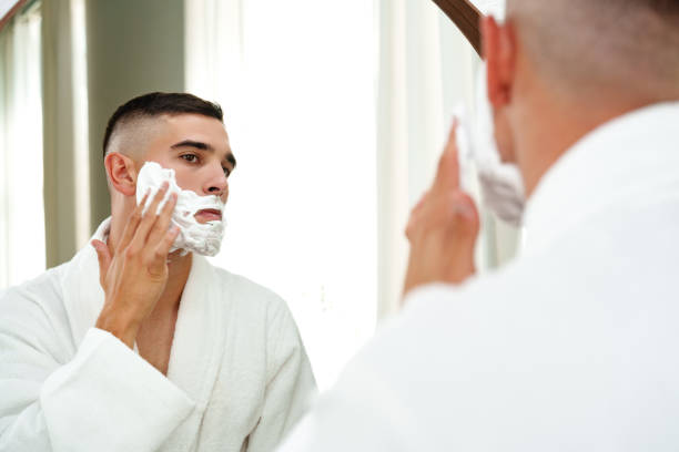 istock Reflection of a young man shaving in bathroom mirror close up 2012022766