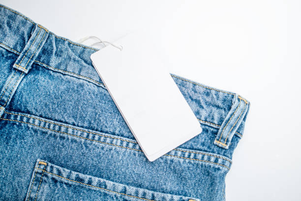 istock Blank white clothing tag on new denim jeans. Template for your design 2012024324