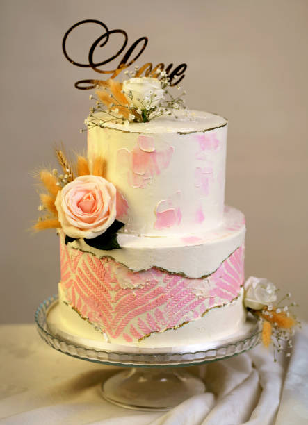 istock Festive wedding bunk cake decorated with fresh flowers on a dark background 2012031514
