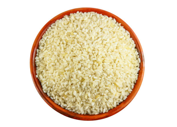 istock White rice in clay bowl isolated on a white background, Top view 2012037735