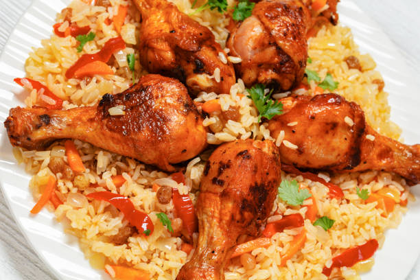 istock fried chicken drumsticks over rice pilaf, top view 2012084987